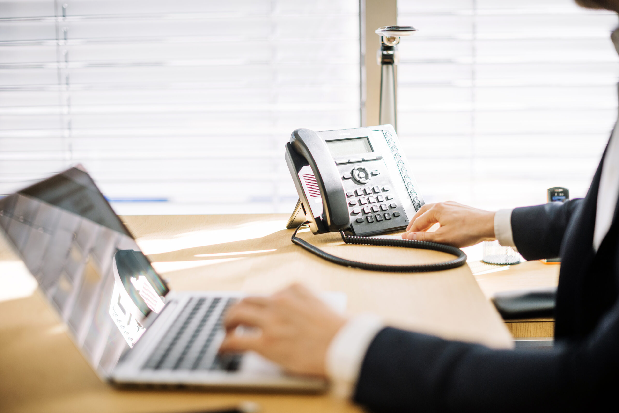 VoIP vs. Traditional Phones: What Eastern Idaho Businesses Should Know man using laptop office
